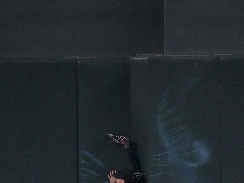 Oct 1, 2023; Phoenix, Arizona, USA; Arizona Diamondbacks center fielder Alek Thomas (5) is unable to make a catch against the wall during the second inning of the game against the Houston Astros at Chase Field. Mandatory Credit: Joe Camporeale-USA TODAY Sports