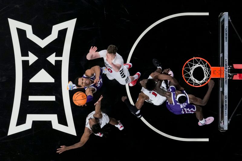 sJan 16, 2024; Cincinnati, Ohio, USA;  TCU Horned Frogs guard Jameer Nelson Jr. (4) drives to the basket against Cincinnati Bearcats forward Viktor Lakhin (30) and guard Day Day Thomas (1) in the second half at Fifth Third Arena. Mandatory Credit: Aaron Doster-USA TODAY Sports