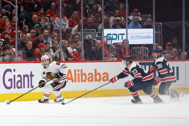 Mar 9, 2024; Washington, District of Columbia, USA; Chicago Blackhawks center Connor Bedard (98) skates with the puck as Washington Capitals center Michael Sgarbossa (23) defends in the third period at Capital One Arena. Mandatory Credit: Geoff Burke-USA TODAY Sports