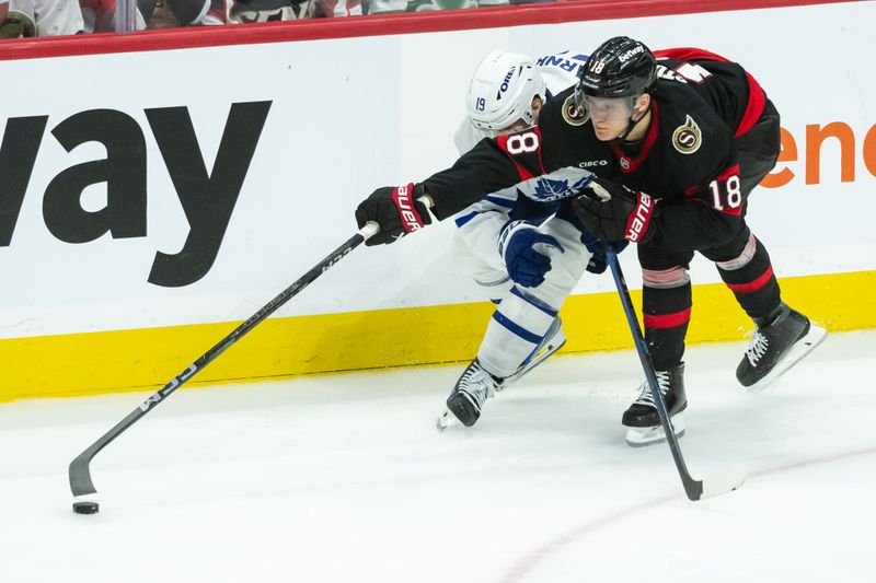 Apr 26, 2025; Ottawa, Ontario, CAN; Ottawa Senators center Tim Stutzle (18) reaches for the puck as he battles with Toronto Maple Leafs center Calle Jarnkrok (19) in overtime in game four of the first round of the 2025 Stanley Cup Playoffs at Canadian Tire Centre. Mandatory Credit: Marc DesRosiers-Imagn Images