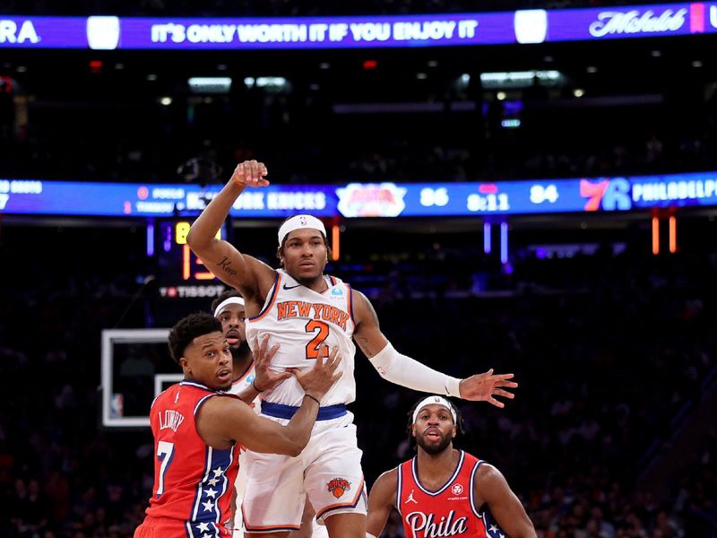 NEW YORK, NEW YORK - APRIL 20: Miles McBride #2 of the New York Knicks passes the ball as Kyle Lowry #7 and Buddy Hield #17 of the Philadelphia 76ers defend during the second half in game one of the Eastern Conference First Round Playoffs at Madison Square Garden on April 20, 2024 in New York City. The New York Knicks defeated the Philadelphia 76ers 111-104. NOTE TO USER: User expressly acknowledges and agrees that, by downloading and or using this photograph, User is consenting to the terms and conditions of the Getty Images License Agreement. (Photo by Elsa/Getty Images)