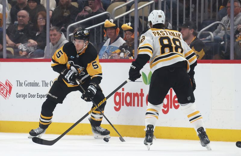Apr 13, 2025; Pittsburgh, Pennsylvania, USA;  Pittsburgh Penguins defenseman Ryan Shea (5) moves the puck against Boston Bruins right wing David Pastrnak (88) during the third period at PPG Paints Arena. Mandatory Credit: Charles LeClaire-Imagn Images