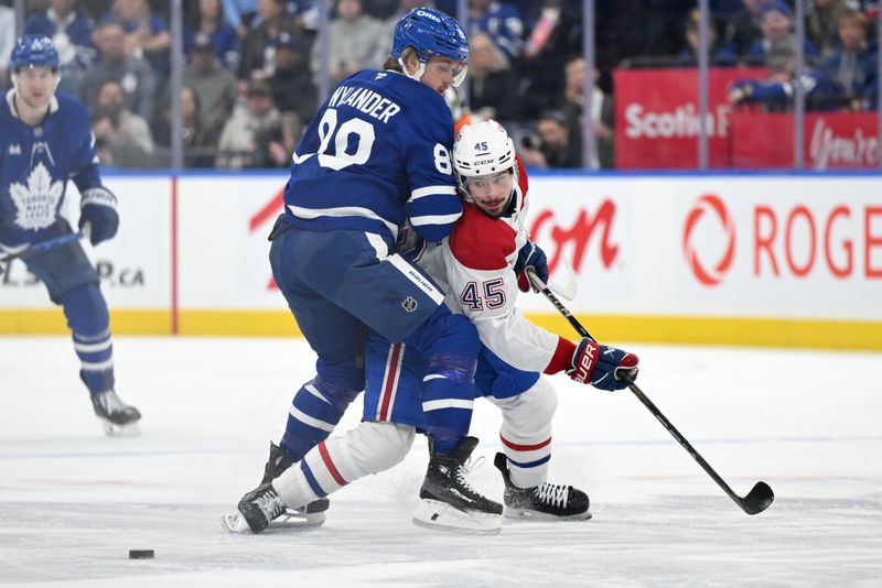 Apr 12, 2025; Toronto, Ontario, CAN;  Toronto Maple Leafs forward William Nylander (88) knocks Montreal Canadiens defenseman Alexandre Carrier (45) off the puck in the first period at Scotiabank Arena. Mandatory Credit: Dan Hamilton-Imagn Images