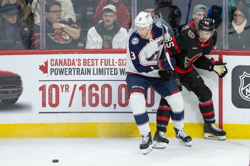 Dec 29, 2025; Ottawa, Ontario, CAN; Columbus Blue Jackets center Charlie Coyle (3) and Ottawa Senators defenseman Jake Sanderson (85) chase the puck in the third period at the Canadian Tire Centre. Mandatory Credit: Marc DesRosiers-IMAGN Images