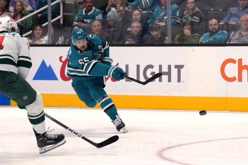 Mar 11, 2023; San Jose, California, USA; San Jose Sharks defenseman Erik Karlsson (65) shoots the puck against the Minnesota Wild during the second period at SAP Center at San Jose. Mandatory Credit: Darren Yamashita-USA TODAY Sports