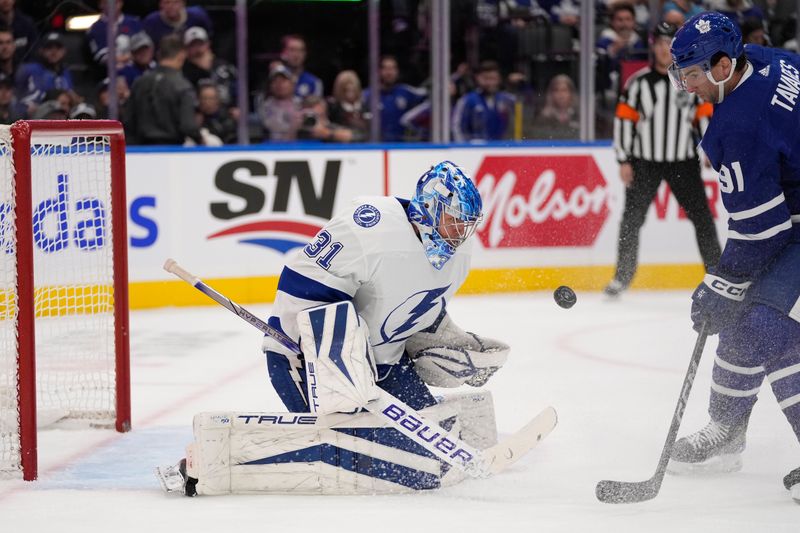 Nov 6, 2023; Toronto, Ontario, CAN; Tampa Bay Lightning goaltender Jonas Johansson (31) makes a save on Toronto Maple Leafs forward John Tavares (91) during the first period at Scotiabank Arena. Mandatory Credit: John E. Sokolowski-USA TODAY Sports