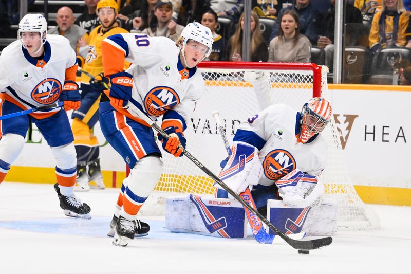 Jan 8, 2026; Nashville, Tennessee, USA; New York Islanders right wing Simon Holmstrom (10) clears the puck from their zone against the Nashville Predators during the first period at Bridgestone Arena. Mandatory Credit: Steve Roberts-Imagn Images
