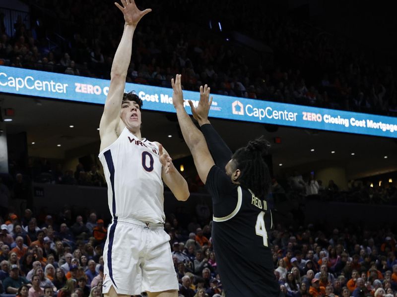 Feb 17, 2024; Charlottesville, Virginia, USA; Virginia Cavaliers forward Blake Buchanan (0) shoots the ball as Wake Forest Demon Deacons forward Efton Reid III (4) defends in the second half at John Paul Jones Arena. Mandatory Credit: Geoff Burke-USA TODAY Sports