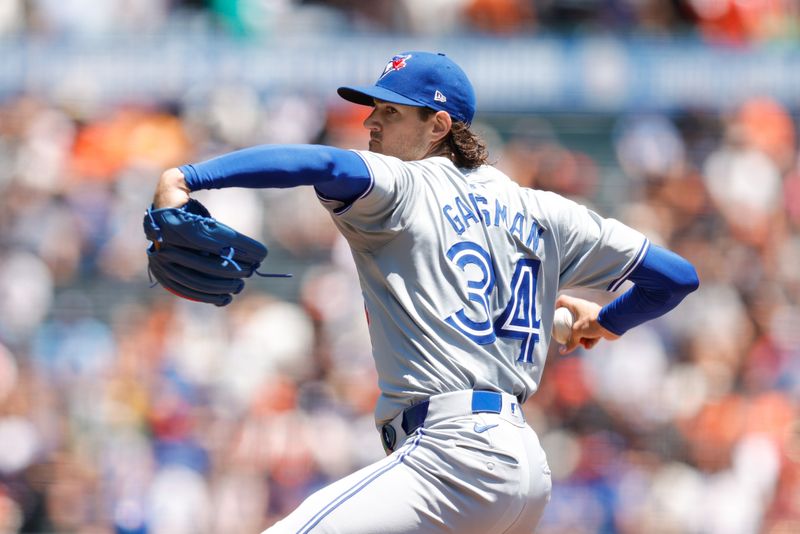 Jul 11, 2024; San Francisco, California, USA; Toronto Blue Jays pitcher Kevin Gausman (34) throws a pitch during the first inning against the San Francisco Giants at Oracle Park. Mandatory Credit: Sergio Estrada-USA TODAY Sports
