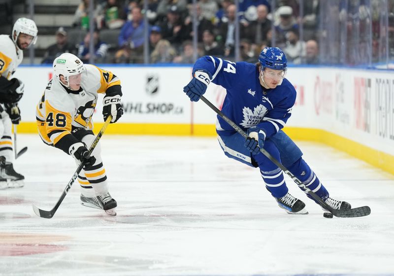 Apr 8, 2024; Toronto, Ontario, CAN; Toronto Maple Leafs center Bobby McMann (74) skates with the puck as Pittsburgh Penguins right wing Valtteri Puustinen (48) tries to defend during the second period at Scotiabank Arena. Mandatory Credit: Nick Turchiaro-USA TODAY Sports