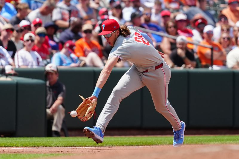 Jun 16, 2024; Baltimore, Maryland, USA; Philadelphia Phillies third baseman Alec Bohm (28) fields a ground ball hit by Baltimore Orioles second baseman Jordan Westburg (not pictured) during the third inning at Oriole Park at Camden Yards. Mandatory Credit: Gregory Fisher-USA TODAY Sports