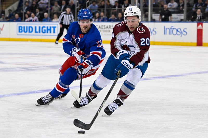 Feb 5, 2024; New York, New York, USA;  Colorado Avalanche center Ross Colton (20) and New York Rangers left wing Alexis Lafreniere (13) battle for a lose puck during the first period at Madison Square Garden. Mandatory Credit: Dennis Schneidler-USA TODAY Sports