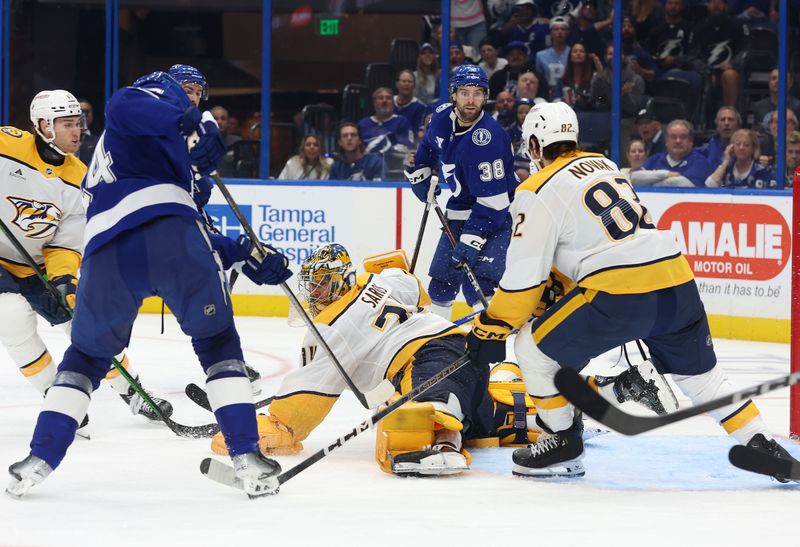 Oct 28, 2024; Tampa, Florida, USA; Nashville Predators goaltender Juuse Saros (74) defends Tampa Bay Lightning center Conor Geekie (14) during the third period at Amalie Arena. Mandatory Credit: Kim Klement Neitzel-Imagn Images