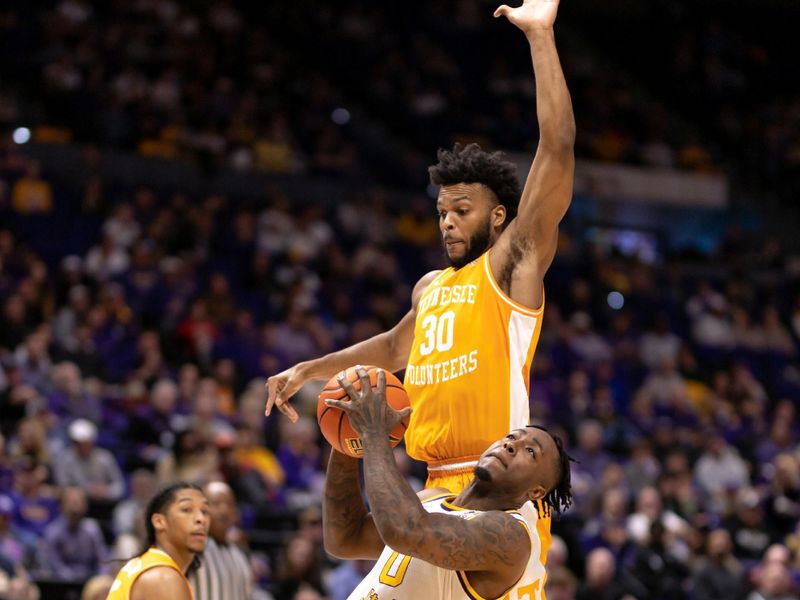 Jan 21, 2023; Baton Rouge, Louisiana, USA; LSU Tigers guard Trae Hannibal (0) drives to the basket against Tennessee Volunteers guard Josiah-Jordan James (30) at Pete Maravich Assembly Center. Mandatory Credit: Stephen Lew-USA TODAY Sports