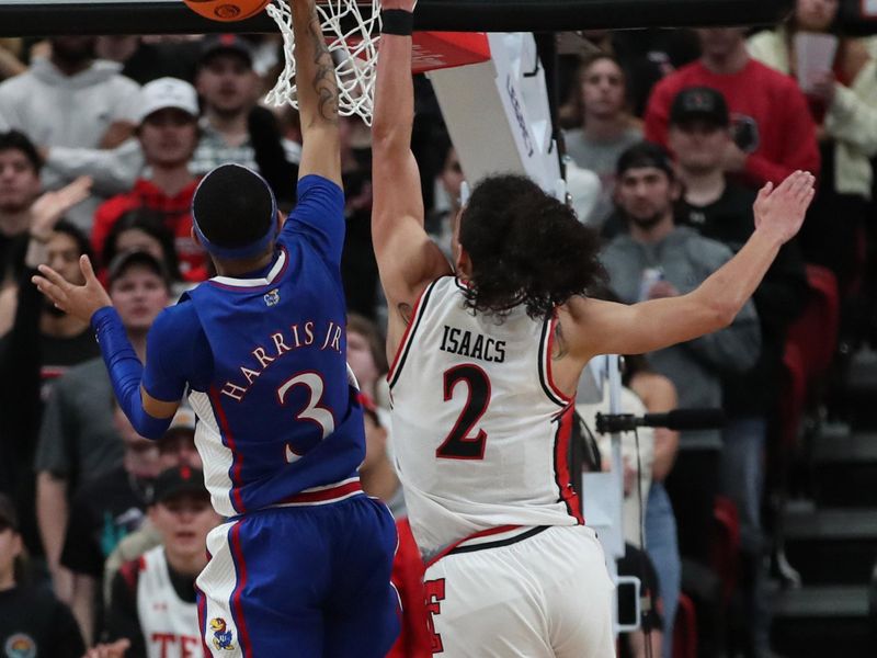 Jan 3, 2023; Lubbock, Texas, USA;  Texas Tech Red Raiders guard Pop Isaacs (2) attempts to block a shot by Kansas Jayhawks guard Dajuan Harris Jr (3) in the second half at United Supermarkets Arena. Mandatory Credit: Michael C. Johnson-USA TODAY Sports