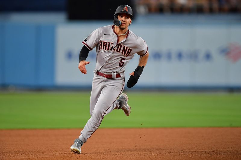 Aug 28, 2023; Los Angeles, California, USA; Arizona Diamondbacks center fielder Alek Thomas (5) runs home to score against the Los Angeles Dodgers during the fourth inning at Dodger Stadium. Mandatory Credit: Gary A. Vasquez-USA TODAY Sports