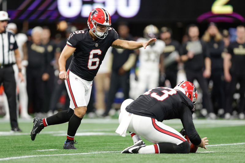 Atlanta Falcons kicker Younghoe Koo (6) kicks a field goal from the hold of punter Bradley Pinion (13) during the second half of an NFL football game against the New Orleans Saints, Sunday, Sept. 29, 2024, in Atlanta. (AP Photo/Stew Milne)