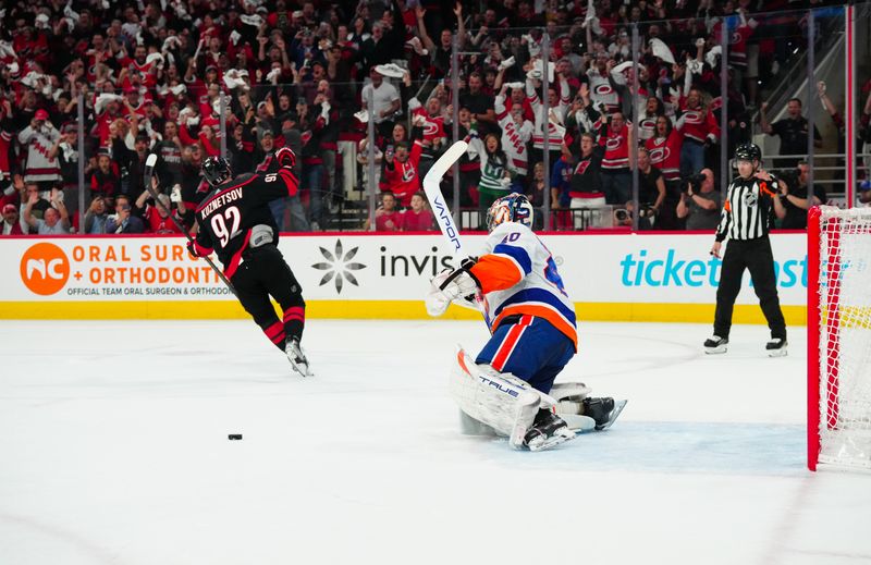 Apr 30, 2024; Raleigh, North Carolina, USA; Carolina Hurricanes center Evgeny Kuznetsov (92) scores a penalty shot goal against New York Islanders goaltender Semyon Varlamov (40) during the first period in game five of the first round of the 2024 Stanley Cup Playoffs at PNC Arena. Mandatory Credit: James Guillory-USA TODAY Sports