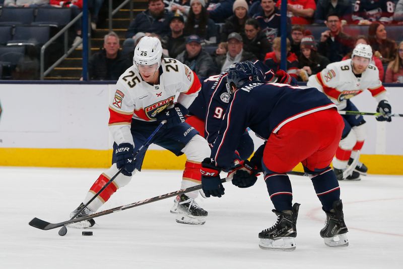 Mar 20, 2025; Columbus, Ohio, USA; Florida Panthers right wing Mackie Samoskevich (25) wrists a shot on goal as Columbus Blue Jackets defenseman Denton Mateychuk (5) defends during the first period at Nationwide Arena. Mandatory Credit: Russell LaBounty-Imagn Images