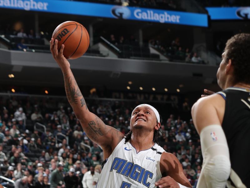 MILWAUKEE, WI - JANUARY 15: Paolo Banchero #5 of the Orlando Magic drives to the basket during the game against the Milwaukee Bucks on January 15, 2025 at Fiserv Forum Center in Milwaukee, Wisconsin. NOTE TO USER: User expressly acknowledges and agrees that, by downloading and or using this Photograph, user is consenting to the terms and conditions of the Getty Images License Agreement. Mandatory Copyright Notice: Copyright 2025 NBAE (Photo by Gary Dineen/NBAE via Getty Images).