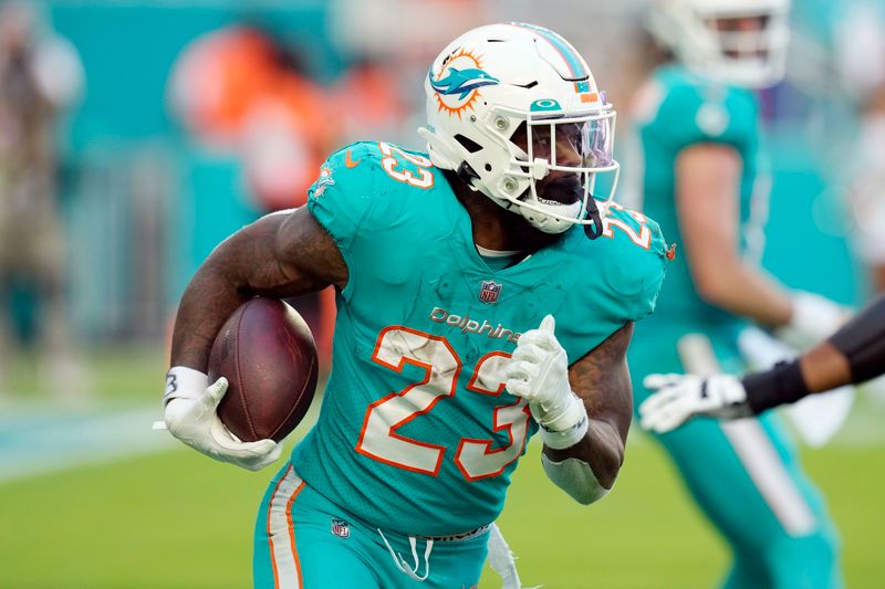 FILE -Miami Dolphins running back Jeff Wilson Jr. (23) runs the ball during the second half of an NFL football game against the New York Jets, Sunday, Jan. 8, 2023, in Miami Gardens, Fla. The Miami Dolphins are bringing back running backs Raheem Mostert and Jeff Wilson Jr., agreeing on two-year contracts for both players, Tuesday, March 14, 2023.(AP Photo/Rebecca Blackwell, File)