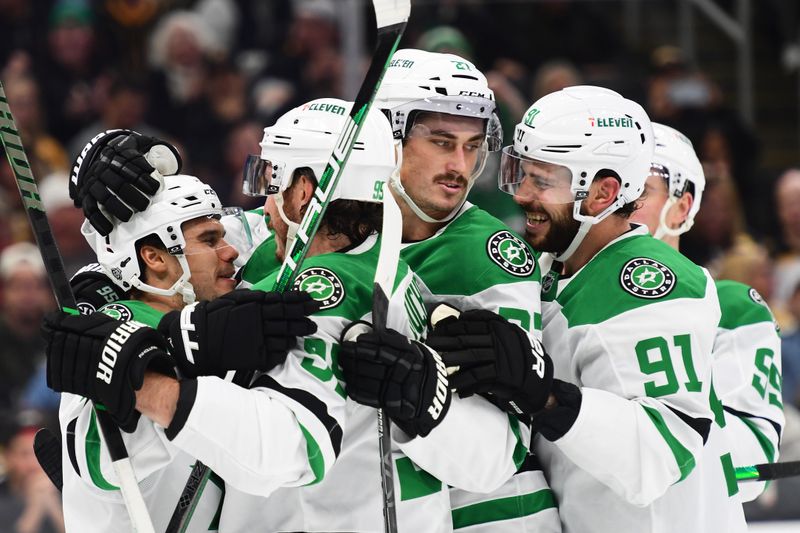 Oct 24, 2024; Boston, Massachusetts, USA;  Dallas Stars center Logan Stankoven (11) is mobbed by his teammates after scoring a goal during the second period against the Boston Bruins at TD Garden. Mandatory Credit: Bob DeChiara-Imagn Images