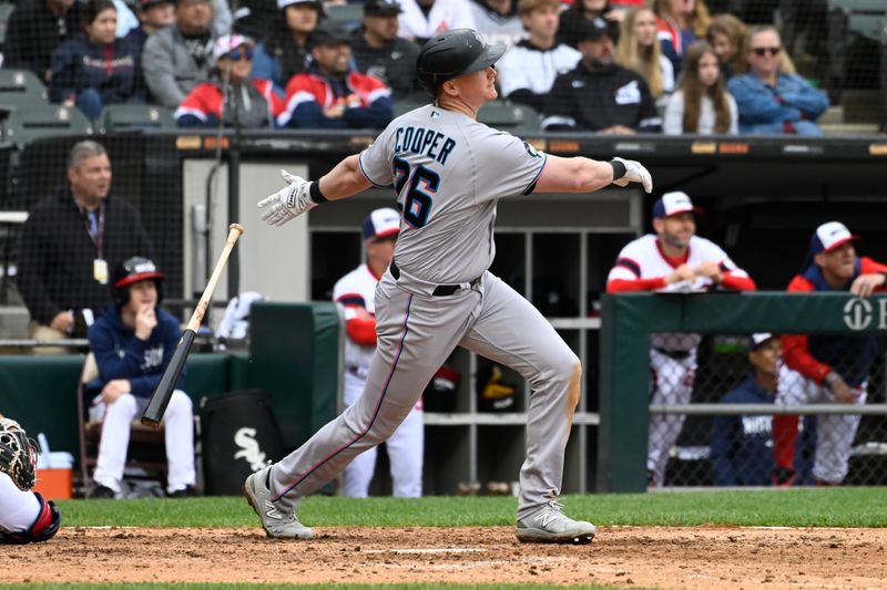 Jun 11, 2023; Chicago, Illinois, USA;  Miami Marlins first baseman Garrett Cooper (26) hits a home run against the Chicago White Sox during the eighth inning at Guaranteed Rate Field. Mandatory Credit: Matt Marton-USA TODAY Sports