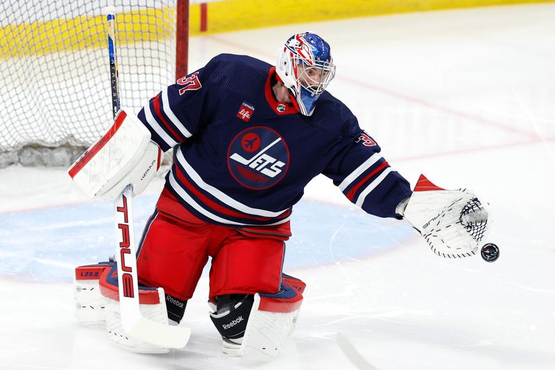 Feb 14, 2024; Winnipeg, Manitoba, CAN; Winnipeg Jets goaltender Connor Hellebuyck (37) warms up before a game against the San Jose Sharks at Canada Life Centre. Mandatory Credit: James Carey Lauder-USA TODAY Sports