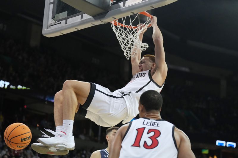 Mar 24, 2024; Spokane, WA, USA; San Diego State Aztecs forward Elijah Saunders (25) dunks the ball in the first half against the Yale Bulldogs at Spokane Veterans Memorial Arena. Mandatory Credit: Kirby Lee-USA TODAY Sports