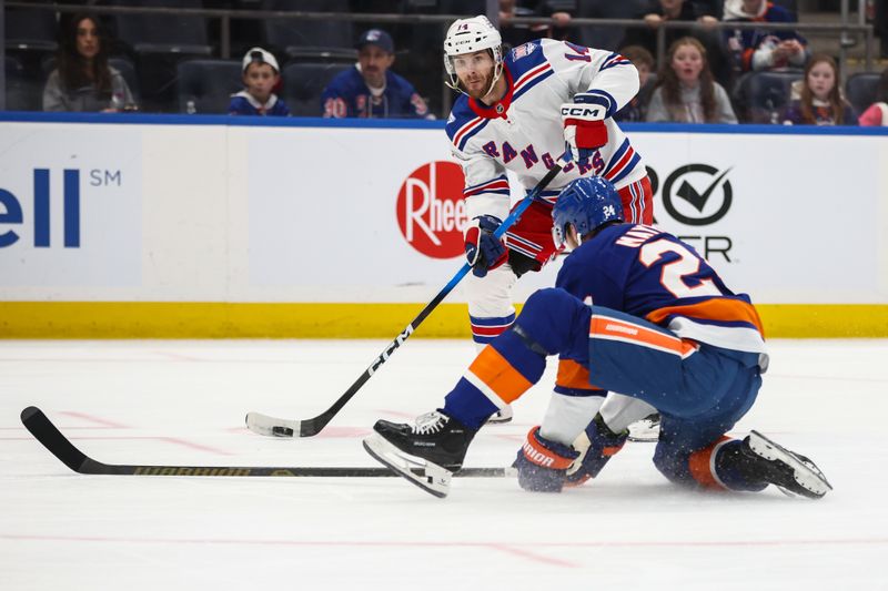 Dec 27, 2025; Elmont, New York, USA;  New York Rangers right wing Taylor Raddysh (14) looks pass against New York Islanders defenseman Scott Mayfield (24) in the first period at UBS Arena. Mandatory Credit: Wendell Cruz-Imagn Images