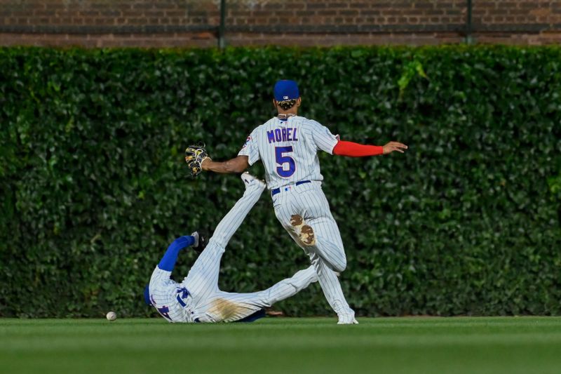 Jul 17, 2023; Chicago, Illinois, USA;  Chicago Cubs center fielder Cody Bellinger (24) and Chicago Cubs center fielder Christopher Morel (5) chase a ball hit by Washington Nationals left fielder Stone Garrett (36) during the fourth inning at Wrigley Field. Mandatory Credit: Matt Marton-USA TODAY Sports