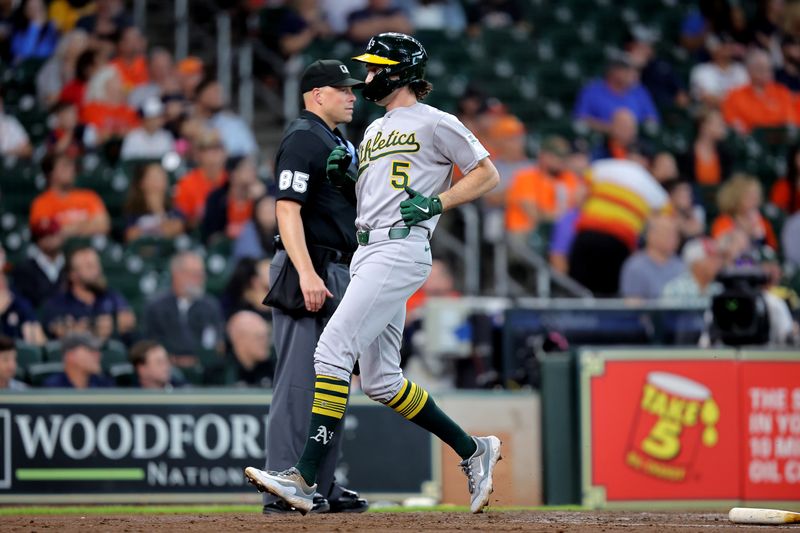 May 28, 2025; Houston, Texas, USA; Athletics shortstop Jacob Wilson (5) crosses home plate to score a run against the Houston Astros during the third inning at Daikin Park. Mandatory Credit: Erik Williams-Imagn Images