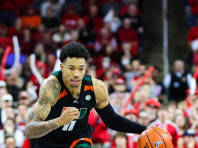 Jan 14, 2023; Raleigh, North Carolina, USA; Miami Hurricanes guard Jordan Miller (11) runs with the ball during the second half against North Carolina State Wolfpack at PNC Arena. Mandatory Credit: Jaylynn Nash-USA TODAY Sports