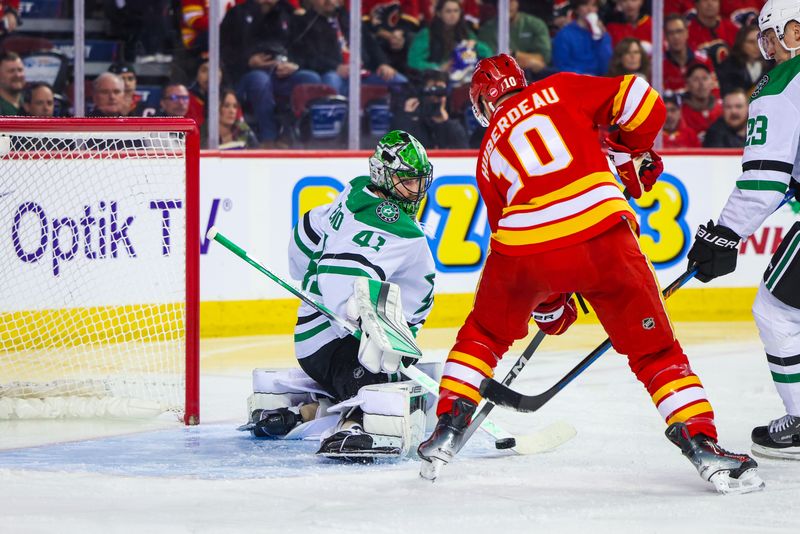 Nov 30, 2023; Calgary, Alberta, CAN; Dallas Stars goaltender Scott Wedgewood (41) makes a save against Calgary Flames center Jonathan Huberdeau (10) during the second period at Scotiabank Saddledome. Mandatory Credit: Sergei Belski-USA TODAY Sports