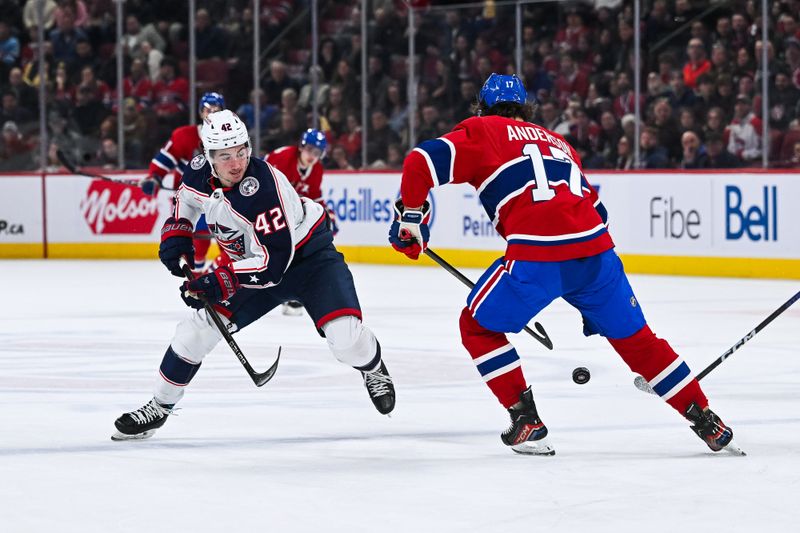 Mar 12, 2024; Montreal, Quebec, CAN; Montreal Canadiens right wing Josh Anderson (17) defends the puck against Columbus Blue Jackets center Alexandre Texier (42) during the second period at Bell Centre. Mandatory Credit: David Kirouac-USA TODAY Sports