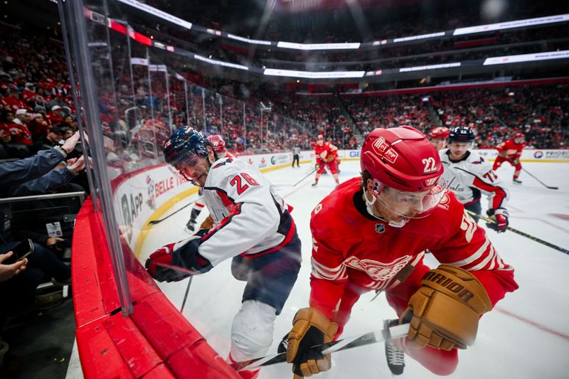 Dec 21, 2025; Detroit, Michigan, USA; Washington Capitals center Nic Dowd (26) and Detroit Red Wings center Mason Appleton (22) battle for the puck during the game at Little Caesars Arena. Mandatory Credit: Tim Fuller-Imagn Images