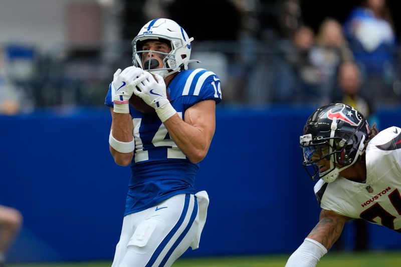 Indianapolis Colts wide receiver Alec Pierce (14) makes a touchdown reception during the first half of an NFL football game against the Houston Texans, Sunday, Sept. 8, 2024, in Indianapolis. (AP Photo/Michael Conroy)