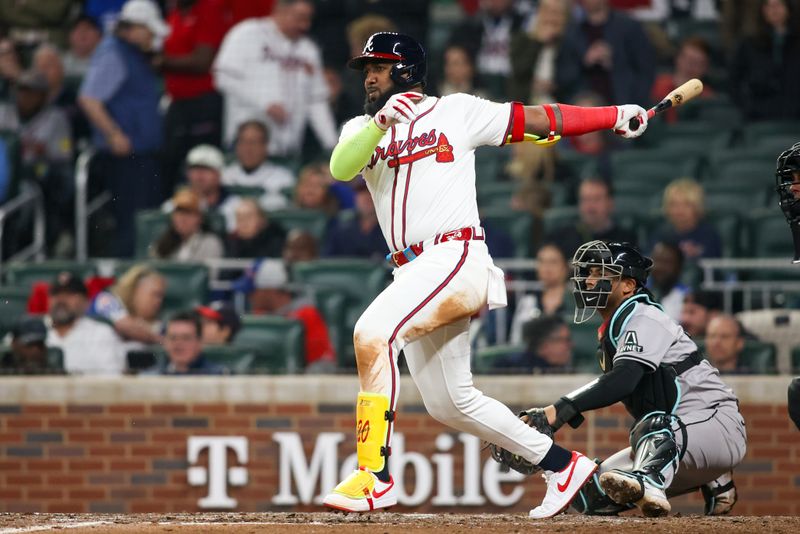 Apr 6, 2024; Atlanta, Georgia, USA; Atlanta Braves designated hitter Marcell Ozuna (20) hits a single against the Arizona Diamondbacks in the seventh inning at Truist Park. Mandatory Credit: Brett Davis-USA TODAY Sports