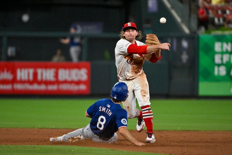 Jul 29, 2024; St. Louis, Missouri, USA;  St. Louis Cardinals second baseman Brendan Donovan (33) throws to first after forcing out Texas Rangers third baseman Josh Smith (8) during the eighth inning at Busch Stadium. Mandatory Credit: Jeff Curry-USA TODAY Sports