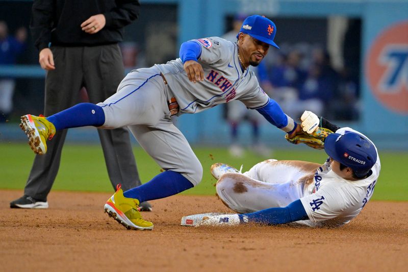 Oct 13, 2024; Los Angeles, California, USA; New York Mets shortstop Francisco Lindor (12) gets the tag on Los Angeles Dodgers two-way player Shohei Ohtani (17) attempting to steal second base in the second inning during game one of the NLCS for the 2024 MLB Playoffs at Dodger Stadium. Mandatory Credit: Jayne Kamin-Oncea-Imagn Images