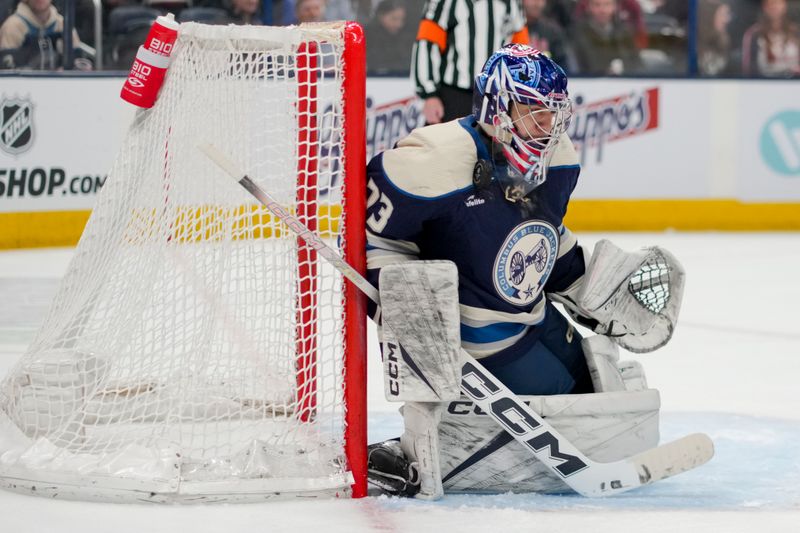 Apr 4, 2024; Columbus, Ohio, USA;  Columbus Blue Jackets goaltender Jet Greaves (73) reacts as the puck deflects off his mask while defending the net against the New York Islanders in the third period at Nationwide Arena. Mandatory Credit: Aaron Doster-USA TODAY Sports