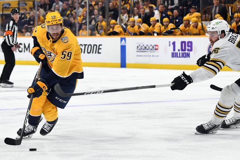 Apr 2, 2024; Nashville, Tennessee, USA; Nashville Predators defenseman Roman Josi (59) skates with the puck against Boston Bruins right wing Justin Brazeau (55) during the first period at Bridgestone Arena. Mandatory Credit: Christopher Hanewinckel-USA TODAY Sports