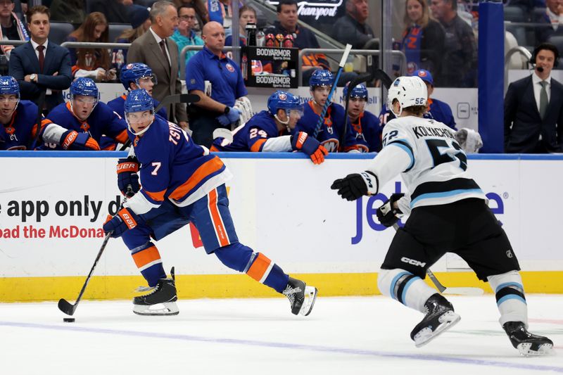 Oct 10, 2024; Elmont, New York, USA; New York Islanders right wing Maxim Tsyplakov (7) controls the puck against Utah Hockey Club defenseman Vladislav Kolyachonok (52) during the second period at UBS Arena. Mandatory Credit: Brad Penner-Imagn Images