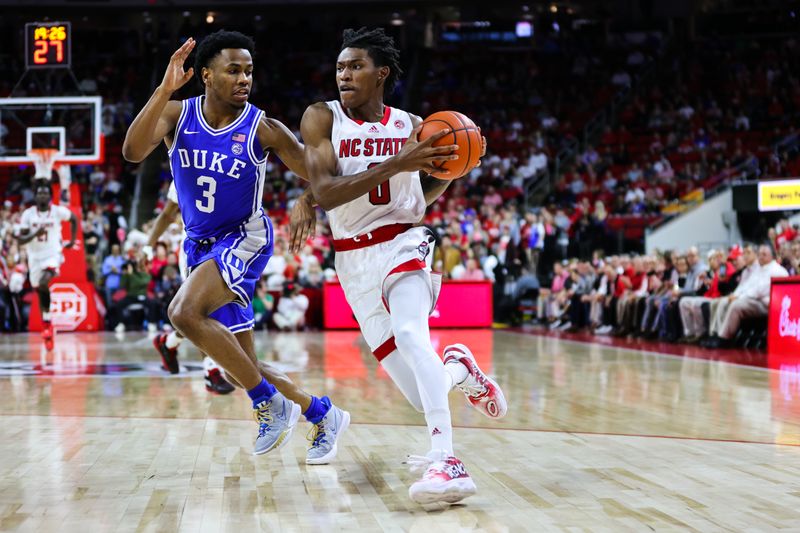 Jan 4, 2023; Raleigh, North Carolina, USA;  North Carolina State Wolfpack guard Terquavion Smith (0) runs with the ball guarded by guard Jeremy Roach (3) during the first half against Duke Blue Devils at at PNC Arena. Mandatory Credit: Jaylynn Nash-USA TODAY Sports