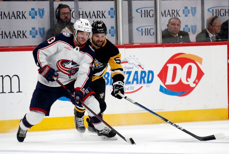 Mar 5, 2024; Pittsburgh, Pennsylvania, USA; Columbus Blue Jackets left wing Johnny Gaudreau (13) handles the puck against Pittsburgh Penguins right wing Emil Bemstrom (52) during the third period at PPG Paints Arena.  The Penguins won 5-3. Mandatory Credit: Charles LeClaire-USA TODAY Sports