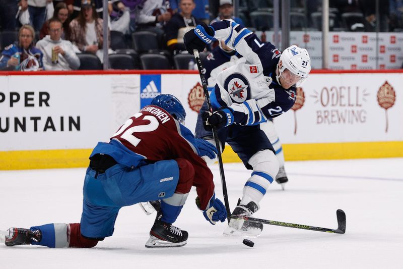 Apr 26, 2024; Denver, Colorado, USA; Winnipeg Jets left wing Nikolaj Ehlers (27) passes the puck as Colorado Avalanche left wing Artturi Lehkonen (62) defends in the first period in game three of the first round of the 2024 Stanley Cup Playoffs at Ball Arena. Mandatory Credit: Isaiah J. Downing-USA TODAY Sports