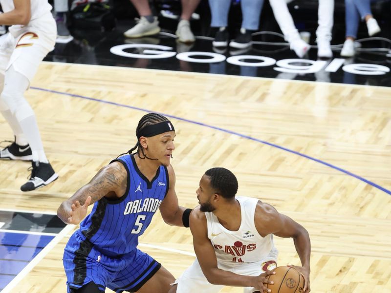 ORLANDO, FL - APRIL 27: Evan Mobley #4 of the Cleveland Cavaliers handles the ball during the game against the Orlando Magic during Round 1 Game 4 of the 2024 NBA Playoffs on April 27, 2024 at the Kia Center in Orlando, Florida. NOTE TO USER: User expressly acknowledges and agrees that, by downloading and or using this photograph, User is consenting to the terms and conditions of the Getty Images License Agreement. Mandatory Copyright Notice: Copyright 2024 NBAE (Photo by David Sherman/NBAE via Getty Images)