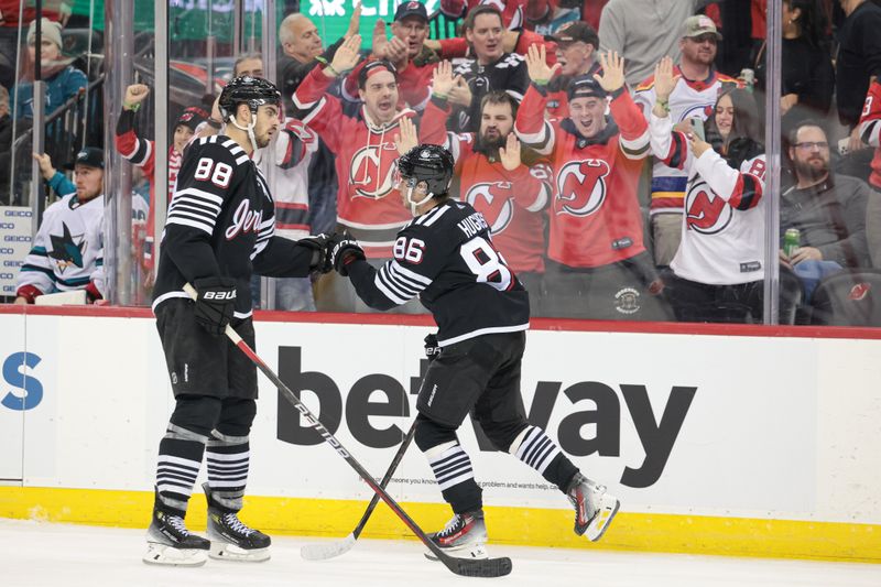 Dec 1, 2023; Newark, New Jersey, USA; New Jersey Devils center Jack Hughes (86) celebrates his goal with defenseman Kevin Bahl (88) during the third period against the San Jose Sharks at Prudential Center. Mandatory Credit: Vincent Carchietta-USA TODAY Sports