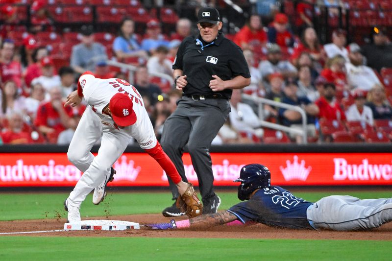 Aug 6, 2024; St. Louis, Missouri, USA;  Tampa Bay Rays center fielder Jose Siri (22) slides safely past the tag of St. Louis Cardinals third baseman Nolan Arenado (28) for a stolen base during the fourth inning at Busch Stadium. Mandatory Credit: Jeff Curry-USA TODAY Sports