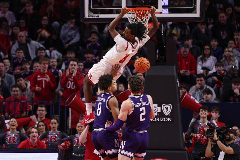 Jan 11, 2026; Piscataway, New Jersey, USA; Rutgers Scarlet Knights forward Bryce Dortch (4) hangs on the rim after a dunk in front of Northwestern Wildcats forward Tre Singleton (8) and forward Nick Martinelli (2) during the first half at Jersey Mike's Arena. Mandatory Credit: Vincent Carchietta-Imagn Images